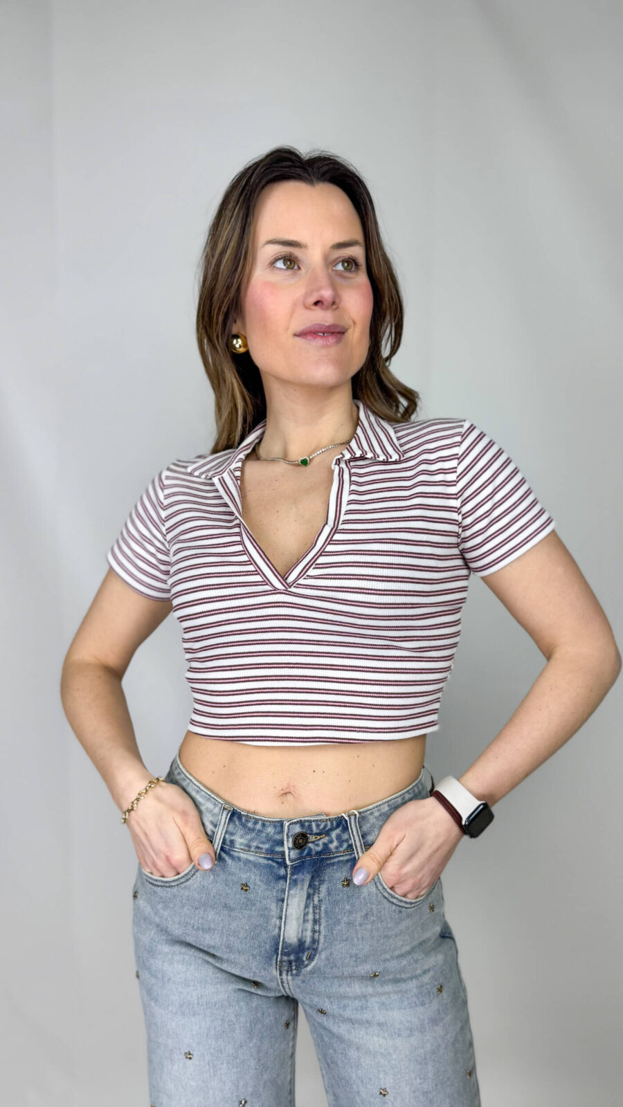 Dona carattere ai tuoi look con questo top crop a righe, perfetto per unire eleganza e freschezza in un capo versatile. Il design corto valorizza la silhouette, mentre lo scollo a V slancia il décolleté aggiungendo un tocco femminile. Il collo a camicia, invece, richiama uno stile più strutturato e sofisticato, creando un equilibrio perfetto tra casual e chic