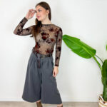 Aggiungi eleganza e modernità al tuo guardaroba con questi sofisticati pantaloni culotte colore grigio antracite/scuro. Caratterizzati da un taglio cropped a gamba molto ampia, offrono la combinazione perfetta tra la raffinatezza di una gonna e la praticità di un pantalone palazzo. Design e Dettagli: Struttura a vita alta impreziosita da eleganti pinces frontali che creano un bellissimo movimento e da una cintura coordinata in stoffa che segna e valorizza il punto vita. Vestibilità e Comfort: Gamba larga e fluida che cade morbida a metà polpaccio, garantendo massima libertà di movimento e una silhouette slanciata. Come Abbinarli: Perfetti da indossare con stivaletti o tronchetti in pelle, un body aderente o un maglioncino inserito all'interno per un look da ufficio impeccabile o un outfit serale chic ed eclettico.